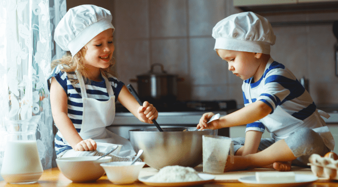 2 children baking in the kitchen